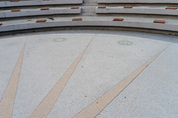 Architectural outdoor amphitheater detail with rays on the floor and zodiac signs and seats for spectators. - 374927850