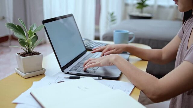 woman busy typing keyboard on laptop at home. Working at home concept.