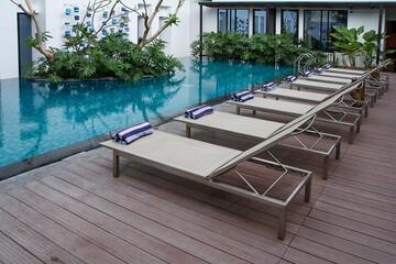 Deck chair and swimming pool with green vertical garden