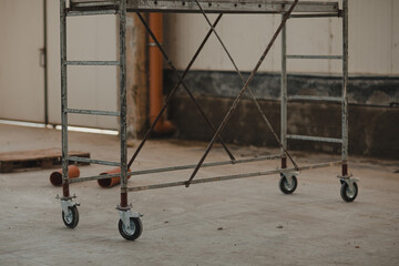 Wheel of scaffolding with shadow on concrete ground in site