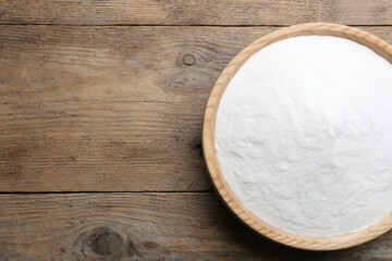 Baking soda on wooden table, top view. Space for text