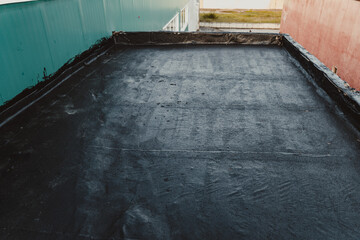 Bitumen roofing, waterproof coatings applied on flat roof.