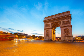 Fototapeta na wymiar The night view of triumphal arch and traffic in Paris, France.