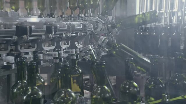 Factory for wine production. Wine factory. Bottles on the bar for filling wine