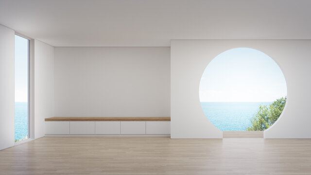 Cabinet on wooden floor of empty large living room in modern new house or luxury hotel. Minimal home interior 3d rendering with beach and sea view.