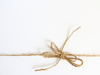 Handmade bow made of natural jute rope at the bottom - decoration for wrapping gifts