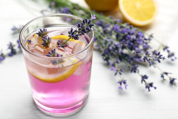 Fresh delicious lemonade with lavender on white wooden table, closeup. Space for text