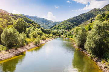 View of the Crnojevic river in Montenegro, the mouth in the mountains on a sunny day and blue sky