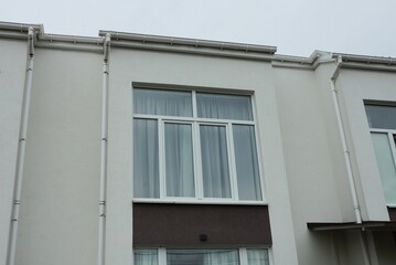 one white big window on the gray concrete wall of the building