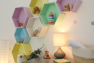 Bright colorful shelves on light wall in room. Interior design
