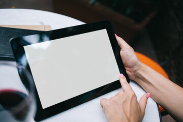 Cropped view of female with modern digital tablet with copy space area for internet advertising, selective focus on hands holding mockup touch pad with blank screen for your web publication