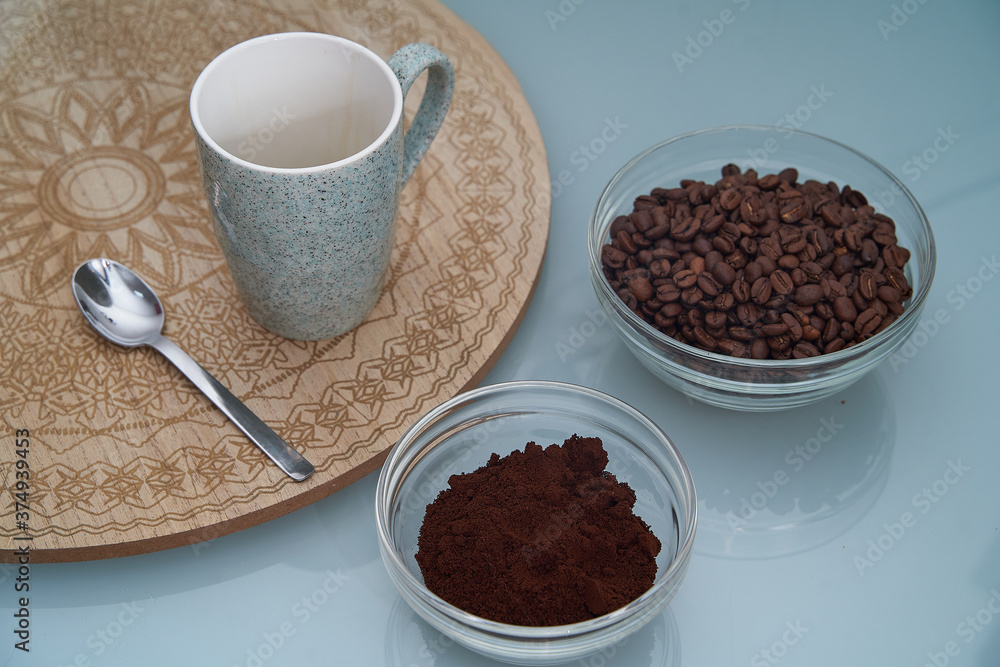 Poster Closeup shot of aromatic coffee beans, melted coffee, cup and spoon