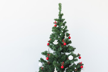 Holidays and celebration concept - Decorated Christmas tree on white background with copy space.