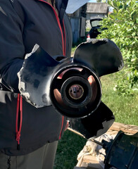 Bent gearbox and broken propeller of outboard motor.