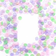 An empty rectangular frame made of multi-colored round confetti is on a white background. Festive background. Flat lay, top view, copy space. Mock up.