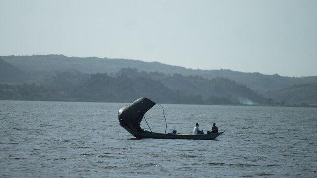 A wooden fishing boat sailing with the help of wind on the lake