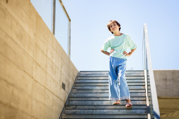 9-year-old girl posing happily on a staircase