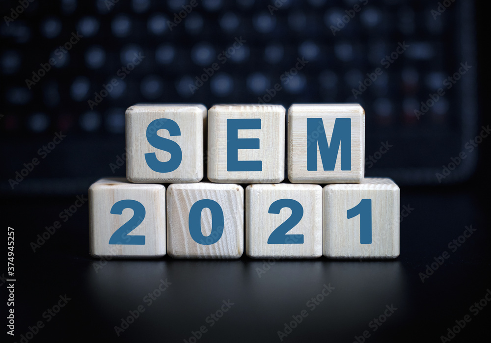 Poster sem 2021 text on wooden cubes on a monochrome background with reflection.
