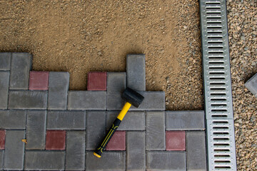 Installation of light metal grating and gutters for drainage of rainwater and paving slabs....