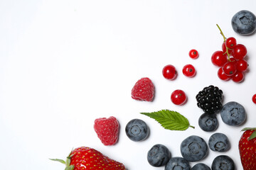 Mix of fresh berries on white background, flat lay. Space for text