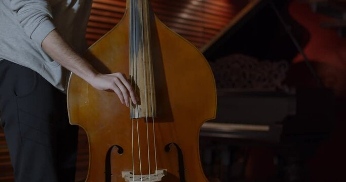 Man playing double bass in professional recording studio / Professional studio / 4K at 60fps (slowmotion) / Professional audio vibes