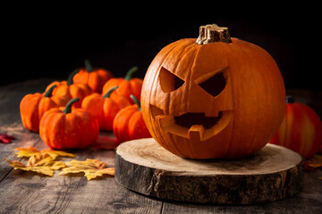 Halloween pumpkin on wooden table and black background. Copy space