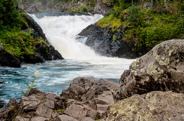 Fototapeta na wymiar Waterfall with rocks in the forest located in Kuusamo, Finland