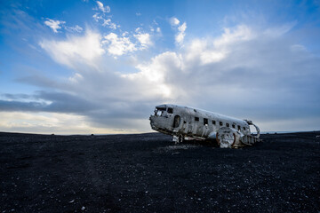 Carcass of an airplane on a black sand beach in Iceland.