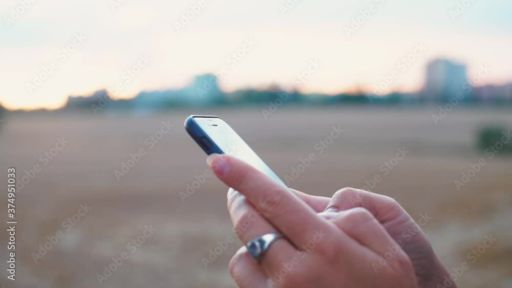 Poster close-up of the phone in the hands of a woman. using a smartphone to view text messages and web page