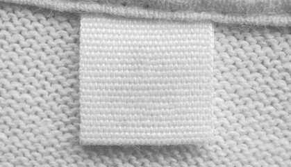 White blank laundry care clothes label on cotton shirt background