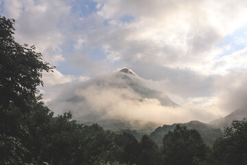 Mountain peak shrouded in clouds after a rainstorm