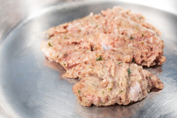Close up of pet food bowl with raw ground turkey meat, inclusive backs, necks, liver and heart....