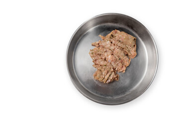 Top view of pet food bowl with raw ground turkey meat, inclusive backs, necks, liver and heart. Stainless steel cat dish. Concept for raw food diet for cats, dogs and pets. Isolated on white.