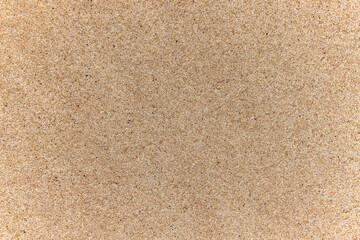 Fototapeta na wymiar Top view of the sandy beach, the background has a copy area and a sandy texture where detail of small pebbles is visible.