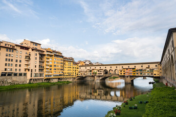 FLORENCE / ITALY - MAY 6 2017: Ponte Vecchio and its surroundings reflected in the Arno river.