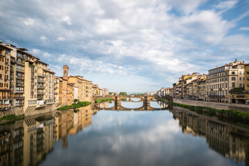 Fototapeta na wymiar FLORENCE / ITALY - MAY 6 2017: Santa Trinita bridge reflected in the Arno river seen from Ponte Vecchio.
