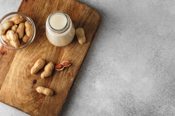 Vegan peanut milk in glass with peanuts