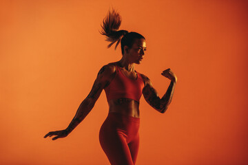 Fototapeta na wymiar Portrait of female athlete with tattoo on arms