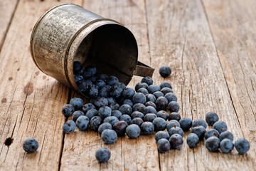 Spilled blueberries on rustic table