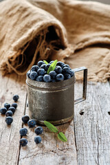 Blueberries inside an old metal cup