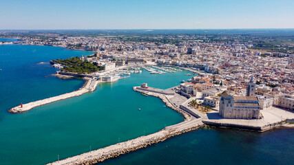 Fototapeta na wymiar Aerial view of Trani in the southeastern region of Apulia in Italy - Entrance to the old port of Trani from above with the Cathedral of San Nicola Pellegrino on the coast of the Adriatic Sea