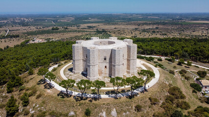 Aerial view of the Castel del Monte in Southern Italy - Octogonal shaped castle built by the Holy Roman Emperor Frederick II in the 13th century in Apulia - obrazy, fototapety, plakaty
