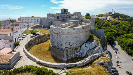 Aerial view of the castle of Monte Sant'Angelo on the Gargano peninsula in Italy, photographed from a drone in flight - Medieval stronghold on a hilltop over the Adriatic Sea - obrazy, fototapety, plakaty