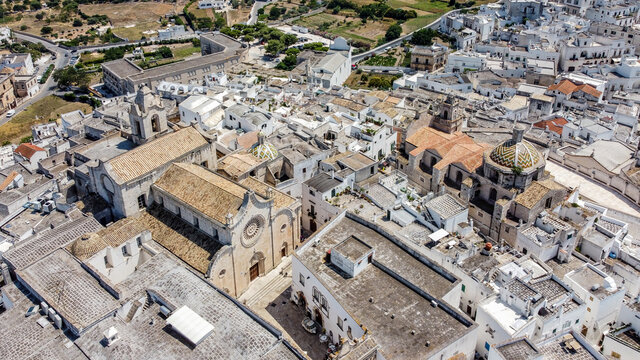 Aerial view of Ostuni "The White City" in Apulia, southern Italy - Romanesque cathedral and Church of Saint Vyth Martyr seen from above