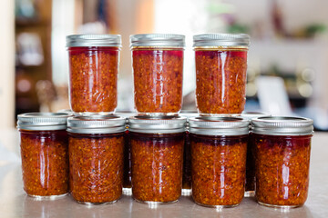 Jars of Thai Chili Paste / Chili Sauce stacked on top of each other. This spicy chili jam is called chili oil, or Naam Prik Phao and Vietnamese Lemongrass Chili Garlic Sate (