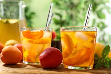 Delicious refreshing drink with apricot on wooden table, closeup