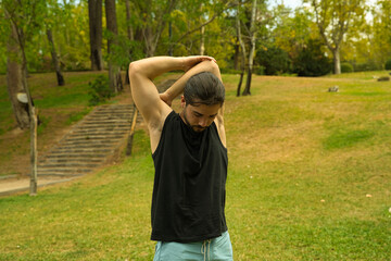 man stretching before calisthenics training in the park