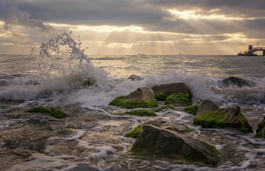Dramatic sunrise on the beach in Burgas, Bulgaria. Sunrise on the Burgas Bridge. Bridge in Burgas - symbol of the city.