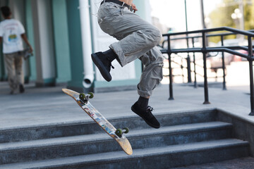Young boy riding trick on skateboard in city