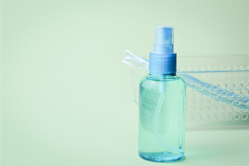 Close-up, hygienic measures, hydroalcoholic gel and surgical masks, on a light background